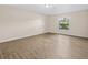 Bedroom showcasing light hardwood floors and a window with natural light at 1035 W Minnehaha Ave, Clermont, FL 34711