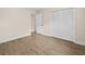 This bedroom features laminate floors, a closet, and a neutral color palette at 1035 W Minnehaha Ave, Clermont, FL 34711