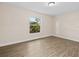 This empty bedroom features updated flooring and a neutral color palette at 1035 W Minnehaha Ave, Clermont, FL 34711