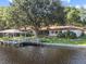 Waterfront home featuring a dock, and a screened in porch at 1035 W Minnehaha Ave, Clermont, FL 34711