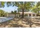Charming single-story home with attached garage, carport, well-kept lawn, and mature trees at 1035 W Minnehaha Ave, Clermont, FL 34711