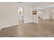 Open living room view leading to the kitchen and fireplace, featuring modern flooring and neutral paint at 1035 W Minnehaha Ave, Clermont, FL 34711