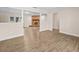 Spacious living room with a fireplace, modern flooring, neutral paint, decorative columns, and natural light at 1035 W Minnehaha Ave, Clermont, FL 34711