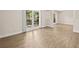 Bright living room featuring modern flooring, neutral paint, and natural light from large windows at 1035 W Minnehaha Ave, Clermont, FL 34711