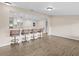 Open-concept living room featuring hardwood floors, bar seating, and a view of the kitchen at 1035 W Minnehaha Ave, Clermont, FL 34711
