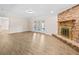 Living room featuring a fireplace, modern flooring, neutral paint, and french doors at 1035 W Minnehaha Ave, Clermont, FL 34711