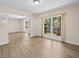 Inviting living room with a large window, modern flooring, neutral paint, and decorative columns at 1035 W Minnehaha Ave, Clermont, FL 34711
