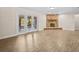 Living room featuring a fireplace, modern flooring, neutral paint, and french doors leading to the water at 1035 W Minnehaha Ave, Clermont, FL 34711
