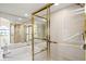 Luxury bathroom featuring a tub, a glass-enclosed shower with gold framing and tiled walls at 1055 Kensington Park Dr # 609, Altamonte Springs, FL 32714