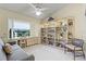 Inviting bedroom with custom shelving, comfortable seating, and a bright window with natural light at 1055 Kensington Park Dr # 609, Altamonte Springs, FL 32714