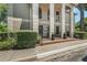 Community building featuring decorative columns and a well-maintained garden at the entrance at 1055 Kensington Park Dr # 609, Altamonte Springs, FL 32714