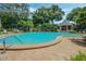 Spacious pool surrounded by lush landscape, lounge chairs, and a quaint gazebo, offering a resort-like experience at 1055 Kensington Park Dr # 609, Altamonte Springs, FL 32714