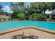 Large community pool surrounded by lounge chairs and lush greenery, perfect for relaxation and recreation at 1055 Kensington Park Dr # 609, Altamonte Springs, FL 32714