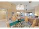 Open-concept dining and living area with a glass table, fireplace, and abundant natural light at 1055 Kensington Park Dr # 609, Altamonte Springs, FL 32714