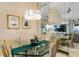 Bright dining room featuring an modern chandelier and glass top dining table for entertaining at 1055 Kensington Park Dr # 609, Altamonte Springs, FL 32714