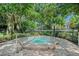 Secluded hot tub surrounded by lush greenery and brick pavers, providing a private and relaxing experience at 1055 Kensington Park Dr # 609, Altamonte Springs, FL 32714