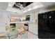 Bright kitchen featuring black appliances, abundant cabinetry, and a glass dining table with seating at 1055 Kensington Park Dr # 609, Altamonte Springs, FL 32714