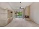 Bright living room featuring a fireplace, built-in shelving, fan, and a sliding glass door to a balcony at 1055 Kensington Park Dr # 609, Altamonte Springs, FL 32714
