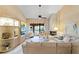 Comfortable living room with vaulted ceiling, fireplace, balcony access, and built-in display at 1055 Kensington Park Dr # 609, Altamonte Springs, FL 32714