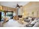 Comfortable living room featuring a brick fireplace and balcony access with natural light at 1055 Kensington Park Dr # 609, Altamonte Springs, FL 32714
