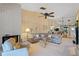 Bright living room featuring a brick fireplace and comfortable sectional sofa for relaxing and entertaining at 1055 Kensington Park Dr # 609, Altamonte Springs, FL 32714