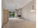 Cozy living room featuring a fireplace, fan, custom shelving, and a sliding glass door to a balcony at 1055 Kensington Park Dr # 609, Altamonte Springs, FL 32714