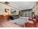 Comfortable lounge area featuring a plush leather couch, cozy chairs, and serene garden views from the windows at 1055 Kensington Park Dr # 609, Altamonte Springs, FL 32714