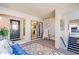Screened outdoor living space with tile floors, white rocking chair, and sliding doors to the kitchen at 1055 Kensington Park Dr # 609, Altamonte Springs, FL 32714