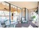 Enclosed patio featuring floral cushioned chairs and a partial view of the interior at 1055 Kensington Park Dr # 609, Altamonte Springs, FL 32714