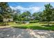 Community pool area with lush greenery, a covered gazebo, and inviting walking paths at 1055 Kensington Park Dr # 609, Altamonte Springs, FL 32714