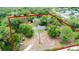 Aerial view of a wooded home with circular horse pasture outlined in red at 1095 Grand Ave, Orange City, FL 32763