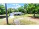 Aerial view of home with an attached garage and fenced yard under a sunny, blue sky at 1095 Grand Ave, Orange City, FL 32763