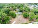 Aerial view of a wooded home with circular horse pasture at 1095 Grand Ave, Orange City, FL 32763