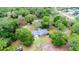 Aerial view of a home with mature trees offering shade and privacy at 1095 Grand Ave, Orange City, FL 32763