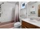 Cozy bathroom with pink fixtures, shower, and a window providing natural light at 1095 Grand Ave, Orange City, FL 32763