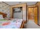 Charming bedroom with wood paneling, sloth-themed wallpaper, a closet and ensuite access at 1095 Grand Ave, Orange City, FL 32763