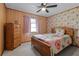 Charming bedroom with wood paneling, sloth-themed wallpaper, and coordinating wooden furniture at 1095 Grand Ave, Orange City, FL 32763
