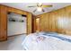Cozy bedroom with neutral carpet, wood paneling, a closet and a bright window at 1095 Grand Ave, Orange City, FL 32763