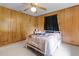 This bedroom has wood paneling, neutral carpet and a bright window view at 1095 Grand Ave, Orange City, FL 32763