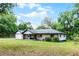 Well-maintained single-story brick home with a lush lawn and mature trees offers a peaceful setting at 1095 Grand Ave, Orange City, FL 32763