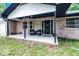 Inviting front porch with outdoor seating creates a welcoming entrance to this charming brick home at 1095 Grand Ave, Orange City, FL 32763