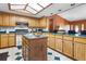Bright kitchen featuring an island, skylight, and ample cabinet space at 1095 Grand Ave, Orange City, FL 32763
