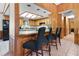 Eat-in kitchen features wood cabinetry, a breakfast bar, and modern appliances with plenty of natural light at 1095 Grand Ave, Orange City, FL 32763