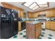 Functional kitchen with an island, black appliances, and plenty of cabinet storage at 1095 Grand Ave, Orange City, FL 32763