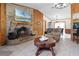 Living room features a brick fireplace, wood paneled walls, and an open layout to the dining area at 1095 Grand Ave, Orange City, FL 32763