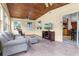 Cozy sunroom with a wood plank ceiling, tile flooring, and lots of light at 1095 Grand Ave, Orange City, FL 32763