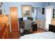 This bedroom features a hardwood floor and a workstation with dual monitors and plenty of storage space at 115 W King St, Orlando, FL 32804