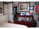 Bedroom with a red couch with accent pillows and a curated display of wall art and decorative accessories at 115 W King St, Orlando, FL 32804