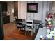Dining area with wood floors and open flow to the kitchen at 115 W King St, Orlando, FL 32804