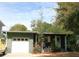 Charming single-story home featuring a one car garage, manicured lawn, and cozy front porch at 115 W King St, Orlando, FL 32804